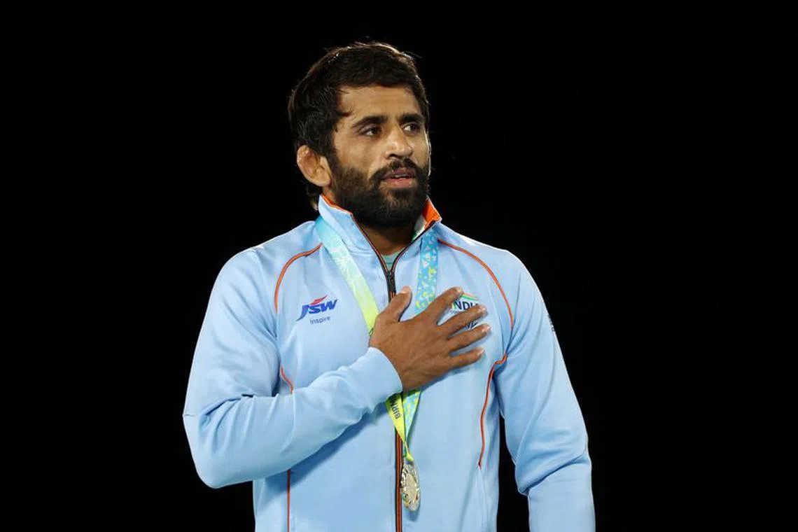 Commonwealth Games - Wrestling - Men's Freestyle 65 kg - Medal Ceremony - Coventry Arena, Coventry, Britain - August 5, 2022 Gold Medallist India's Bajrang Punia celebrates on the podium during the medal ceremony REUTERS/Hannah Mckay/File Photo