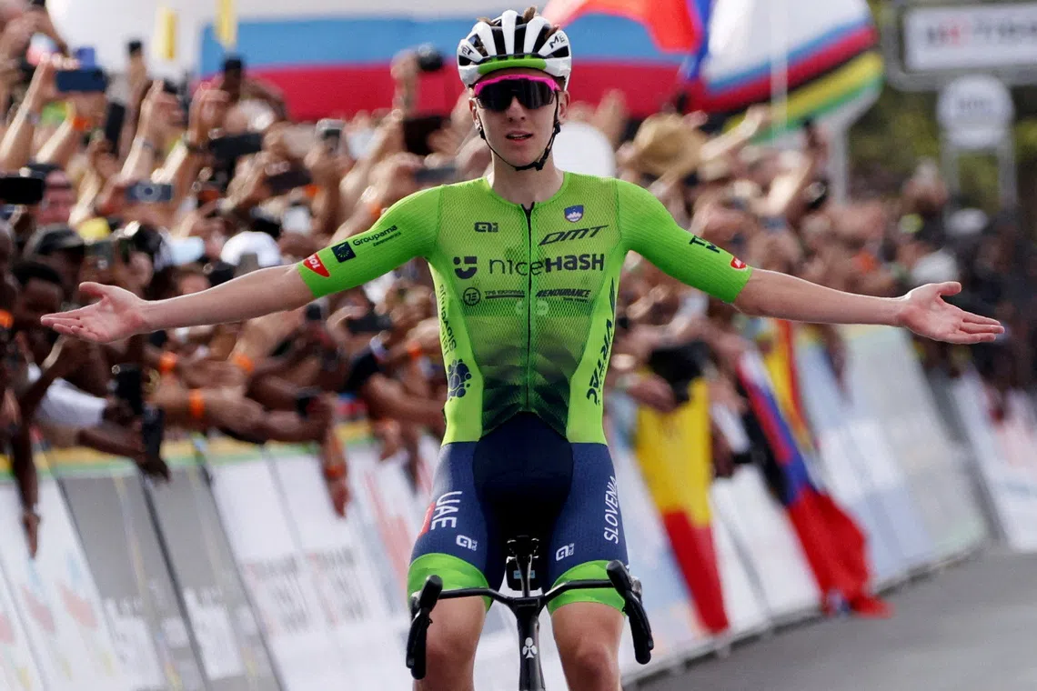 Cycling - Road World Championships 2025 - Kigali, Rwanda - September 28, 2025 Slovenia's Tadej Pogacar celebrates as he crosses the finish line to win the Men's Elite Road Race REUTERS/Jean Bizimana