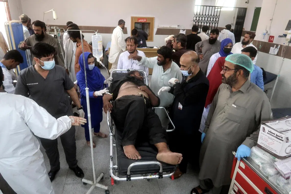 An injured policeman receiving medical treatment following a bomb explosion near a police headquarters in Pishin, Pakistan, on Aug 24.
