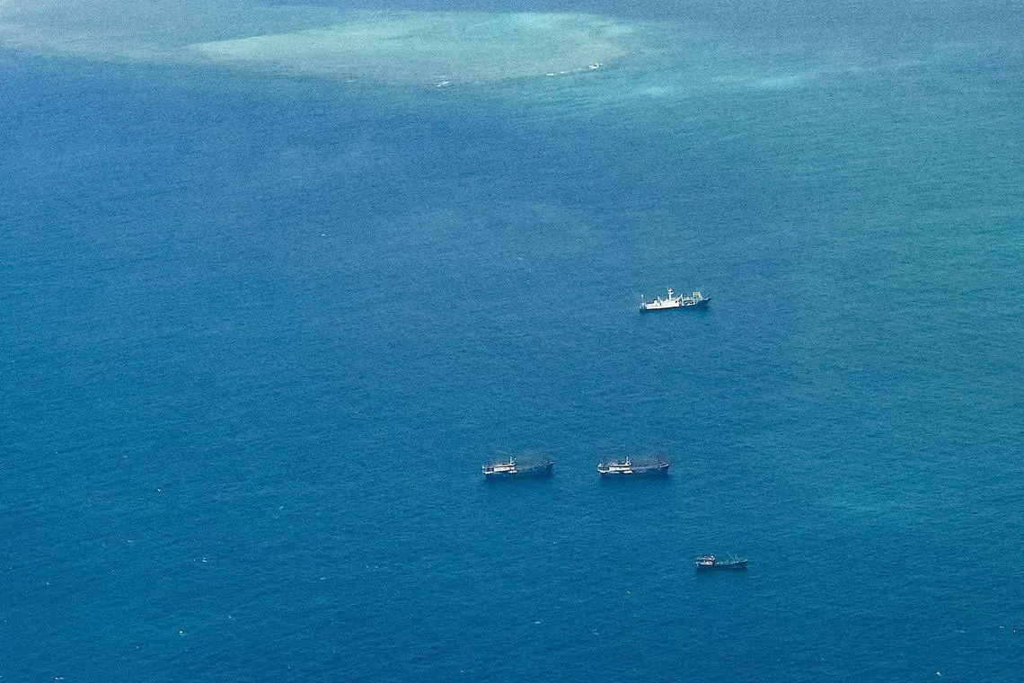 An aerial view taken on March 9, 2023 shows vessels identified by the Philippine Coast Guard as Chinese maritime militia vessels near Thitu Island in the South China Sea. 