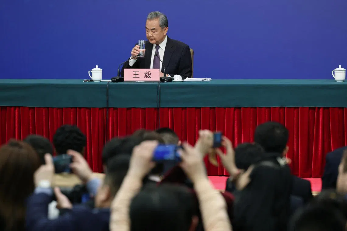 Chinese Foreign Minister Wang Yi holds a glass of water at a press conference on the sidelines of the National People's Congress (NPC) in Beijing, China March 7, 2025. REUTERS/Go Nakamura 