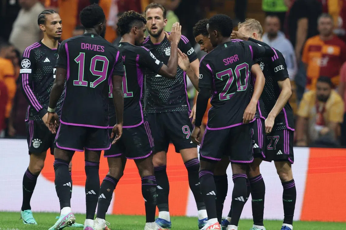 Bayern Munich players celebrating with Jamal Musiala after he scored their third goal against Galatasaray.