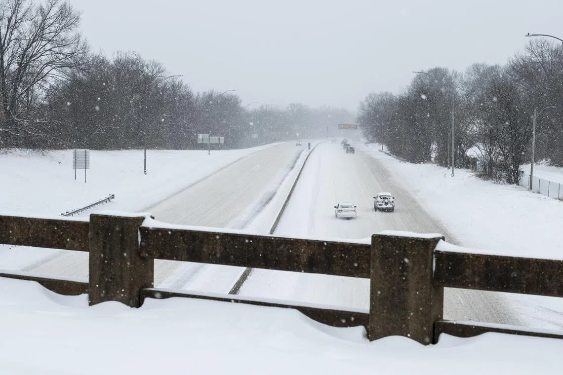 Cars slowly navigate a snowy stretch of I-240 in Memphis, as a winter storm gripped much of Tennessee on Jan. 15, 2024. The extreme cold has been particularly rough for regions not used to prolonged periods of ice and wind chills, including Tennessee, Kentucky and Arkansas. (Brad Vest/The New York Times)