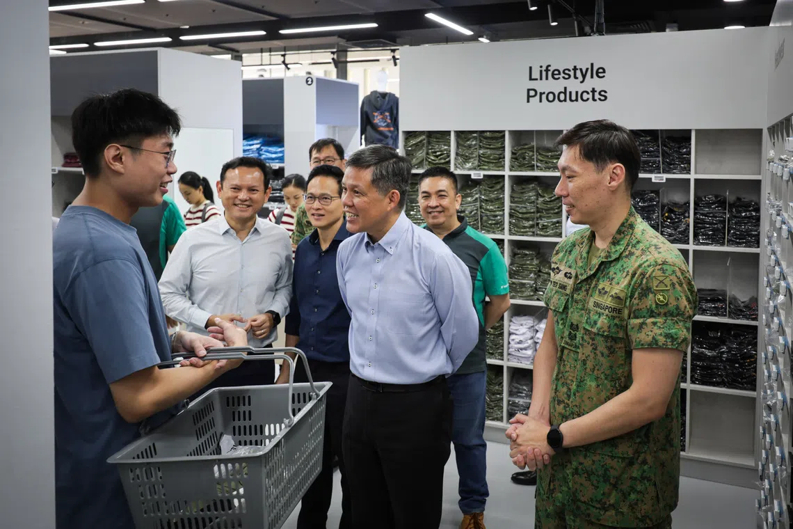Defence Minister Chan Chun Sing (centre) speaking to an NSman during his tour of the Lifestylemart at the new Central Manpower Base in Bukit Gombak on Oct 14.