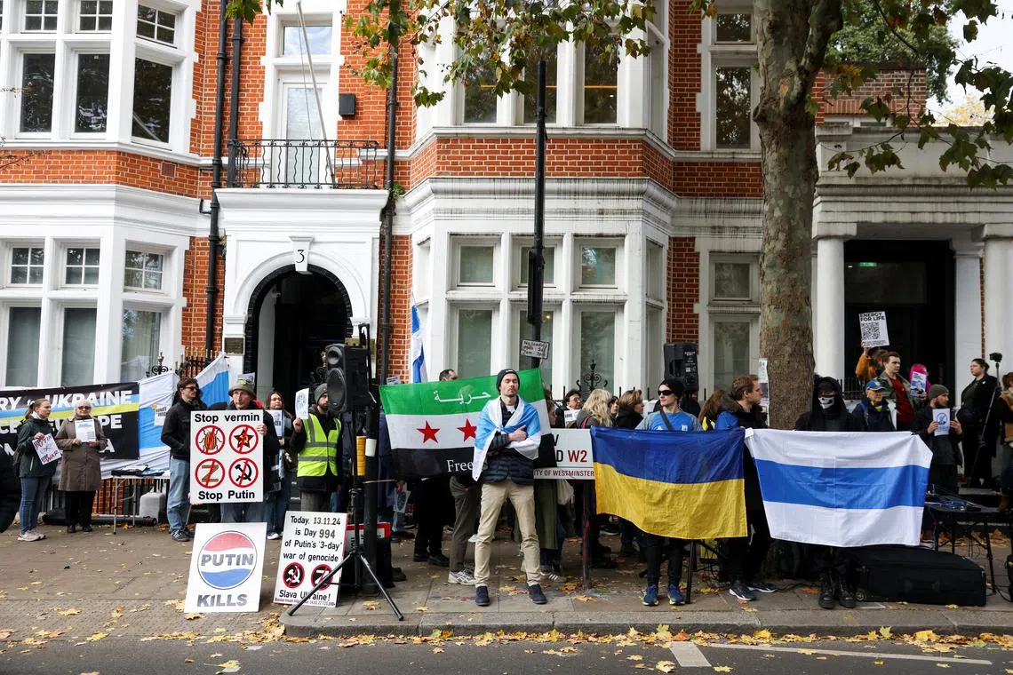 Demonstrators hold placards and flags during a demonstration marking the upcoming anniversary of 1,000 Days since Russia's invasion of Ukraine, outside the Russian Embassy in London, Britain, November 17, 2024. REUTERS/Hollie Adams