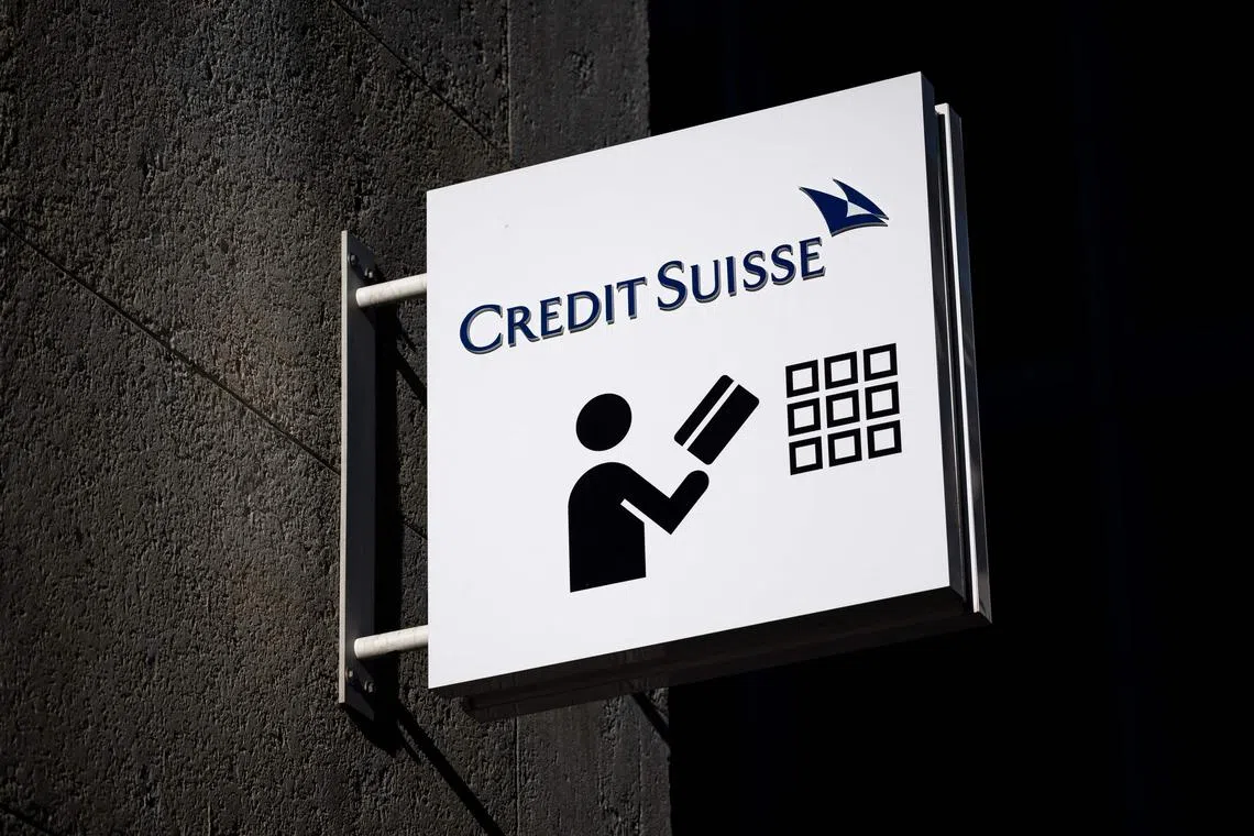 A sign of Credit Suisse bank is seen outside a branch in Geneva, on March 15, 2023. - Credit Suisse shares nosedived on on March 15, 2023, after its main shareholder said it would not provide more funding, with reassuring comments from the Swiss bank's chairman unable to calm the market panic. (Photo by Fabrice COFFRINI / AFP)