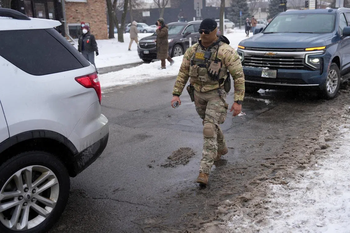 A federal agent walks while immigration enforcement continues after a U.S. Immigration and Customs Enforcement (ICE) agent fatally shot Renee Nicole Good on January 7 during an immigration raid, in Minneapolis, Minnesota, U.S., January 21, 2026. REUTERS/Leah Millis