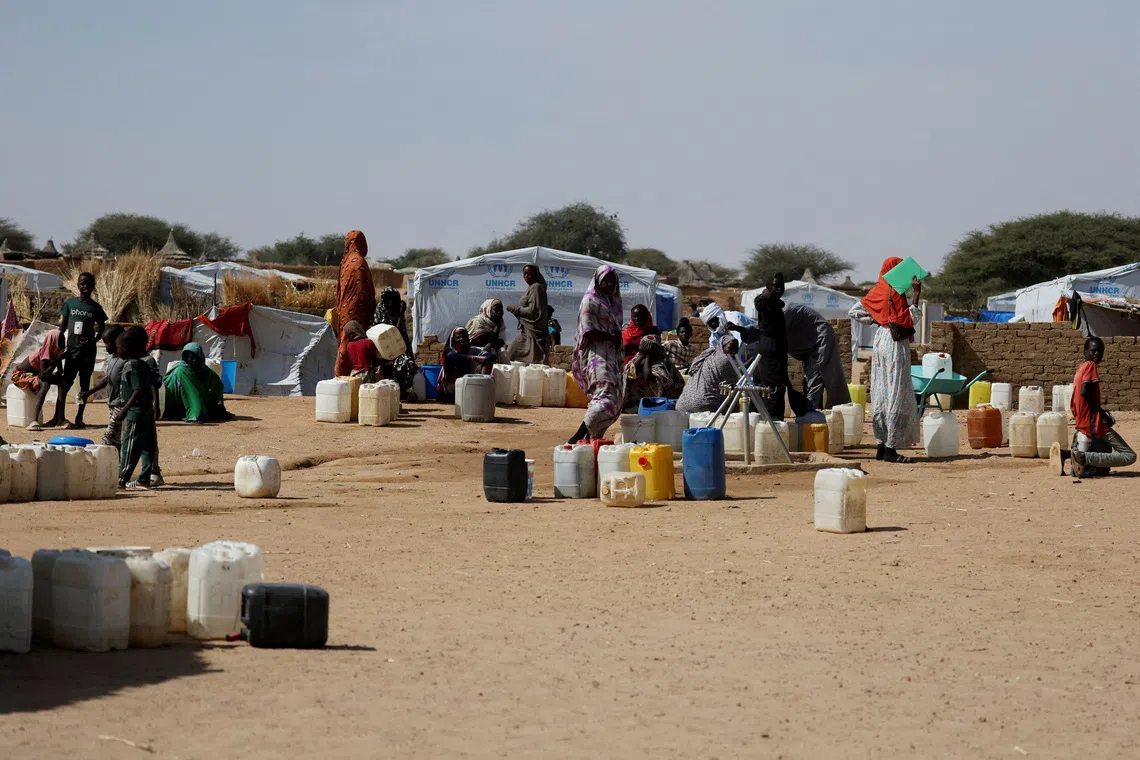 Image 3: Sudanese refugees wait to collect water inside the Iridimi refugee camp, northwest of Iriba, in Wadi Fira province, eastern Chad, November 27, 2025. REUTERS/Amr Abdallah Dalsh  To match Special Report SUDAN-POLITICS/REFUGEES