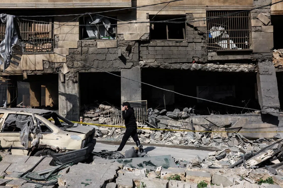 A man walks past a damaged building in the aftermath of Israeli strikes on the Bachoura neighbourhood, following an escalation between Hezbollah and Israel amid the US-Israeli conflict with Iran, Lebanon, on March 13, 2026.