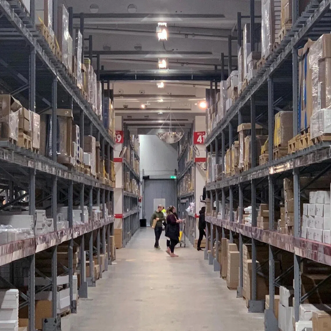 Shoppers are seen in the warehouse section of an IKEA store on the outskirts of Stockholm, Sweden.