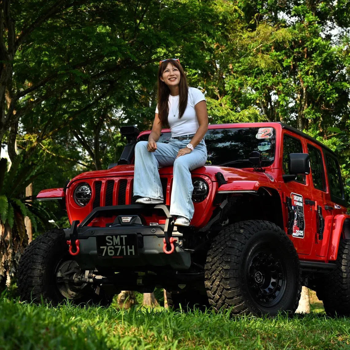 Leong Khay Mun and her red Jeep Wrangler Sahara Unlimited, affectionately dubbed Red Baron.