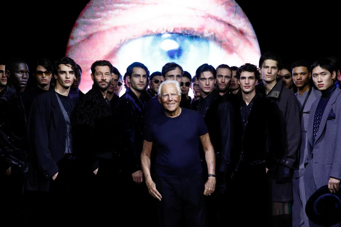 Designer Giorgio Armani poses with models at his Fall/Winter 2024/25 men's collection during Men's Fashion Week in Milan, Italy, on Jan 15, 2024. 