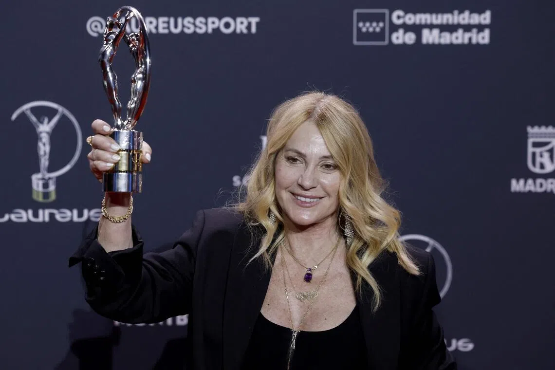 Former Romanian gymnast Nadia Comaneci poses with her Life Achievement Award during the 27th Laureus World Sports Awards gala in Madrid on April 20, 2026. 