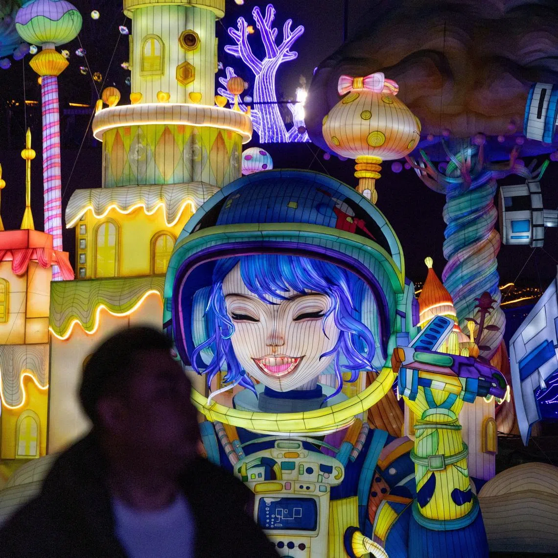 A man looks on next to light installations at the 32nd Zigong International Lantern Festival ahead of the Chinese Lunar New Year, which will welcome the Year of the Horse, in Zigong, Sichuan province, China, January 23, 2026. REUTERS/Maxim Shemetov 