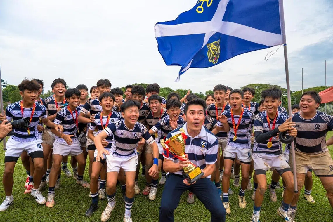 Principal Lee Han Hwa with his students who won the National School Games C Division rugby boys final on Aug 20.