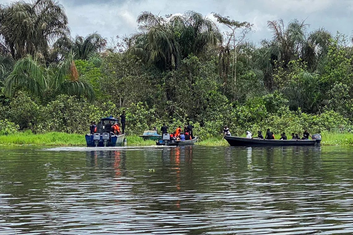 Members of a search and rescue team work in the swampy Igbokoda forest, where a Nigerian military helicopter carrying 32 passengers and crew crashed, on the second day after the crash, in Ondo State, Nigeria, October 6, 2026. REUTERS/Edith Obakpolor