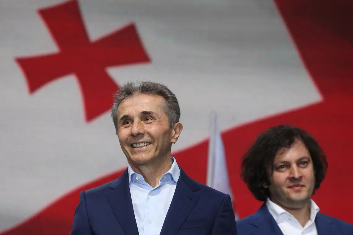 FILE PHOTO: Bidzina Ivanishvili, a former prime minister and founder of the Georgian Dream party, and Georgian Prime Minister Irakli Kobakhidze take part in a pro-government rally in support of a bill on \"foreign agents\" in Tbilisi, Georgia April 29, 2024. REUTERS/Irakli Gedenidze/File Photo