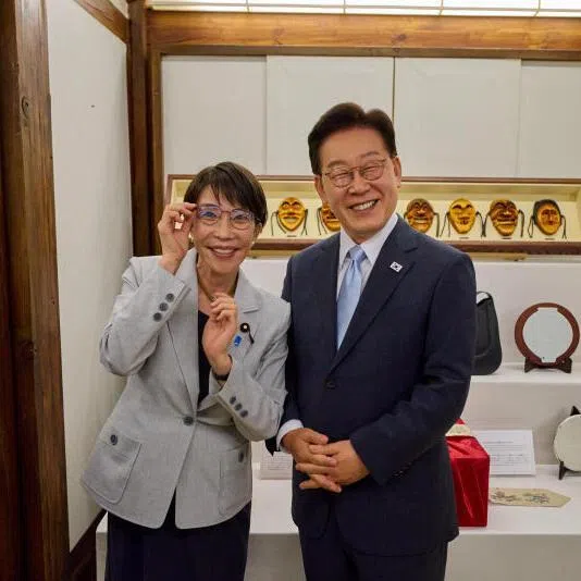 Japanese Prime Minister Sanae Takaichi posing with South Korean President Lee Jae Myung's glasses, during her visit to Andong on May 19.