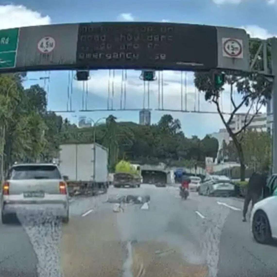 The motorcyclist and pillion rider appear to be lying on the CTE near the Orchard Road exit.