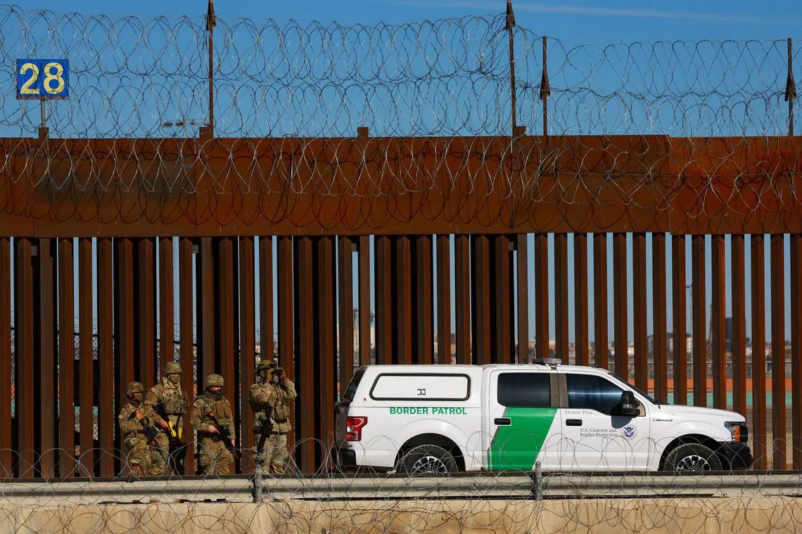 FILE PHOTO: Members of the Texas National Guard stand guard near the border wall between Mexico and the United States, as seen from Ciudad Juarez, Mexico, January  14, 2025. REUTERS/Jose Luis Gonzalez/File Photo