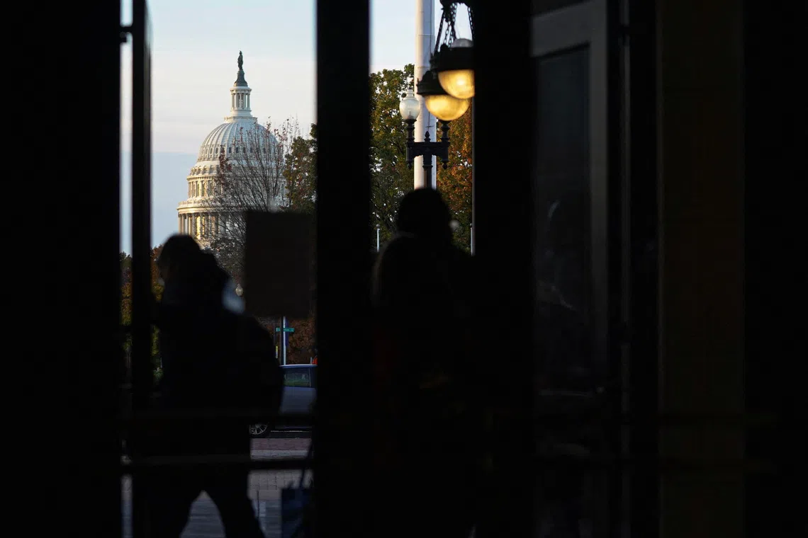 People commute near the U.S. Capitol following the longest U.S. government shutdown in history, on Capitol Hill, in Washington, D.C., U.S., November 13, 2025. REUTERS/Nathan Howard
