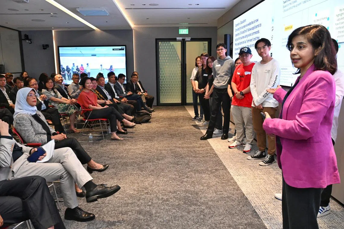 Dr Parveen Sandhu, Principal Specialist, ALC (right) giving a presentation on Singapore Polytechnic's collaboration with the ALC on future-oriented pedagogies for digital marketeers on August 1, 2024. In attendance are Halimah Yacob, SUSS chancellor and Gan Siow Huang, Minister of State for Education and Manpower.