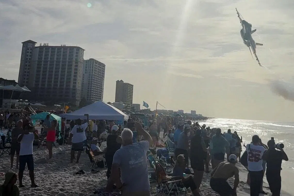 A Navy Blue Angels jet flies low over the crowd on Pensacola Beach, in Florida, U.S., July 15, 2026, in this screengrab obtained from a social media video. Partridge Drones via Facebook/via REUTERS THIS IMAGE HAS BEEN SUPPLIED BY A THIRD PARTY. MANDATORY CREDIT. NO RESALES. NO ARCHIVES. THIS PICTURE WAS PROCESSED BY REUTERS TO ENHANCE QUALITY. AN UNPROCESSED VERSION HAS BEEN PROVIDED SEPARATELY. VERIFICATION: - Pier, beach and buildings matched archive and satellite images - Location and date also verified by original file metadata TPX IMAGES OF THE DAY