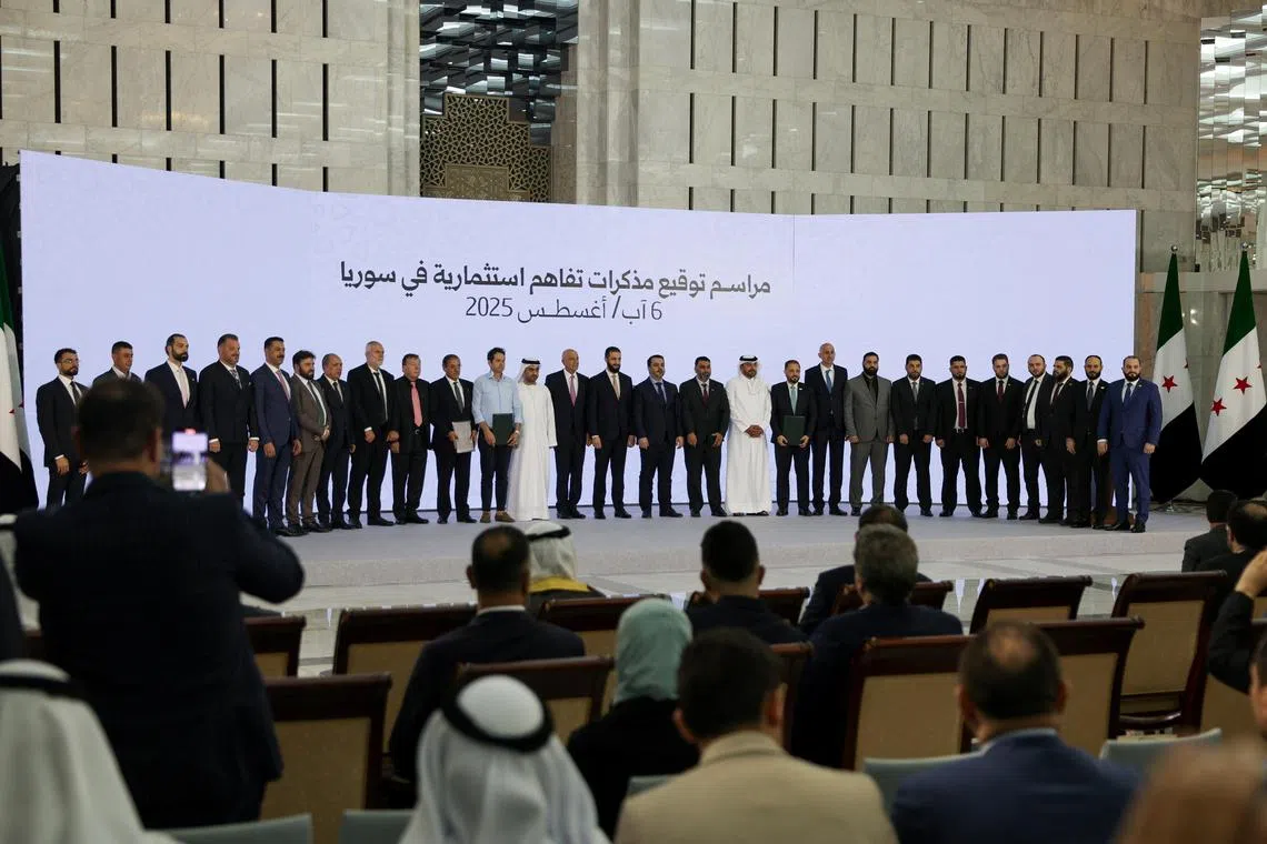 Syria's interim president, Mr Ahmed al-Sharaa (centre), posing for a group photo during the Aug 6 signing ceremony for investment deals worth US$14 billion (S$18 billion).