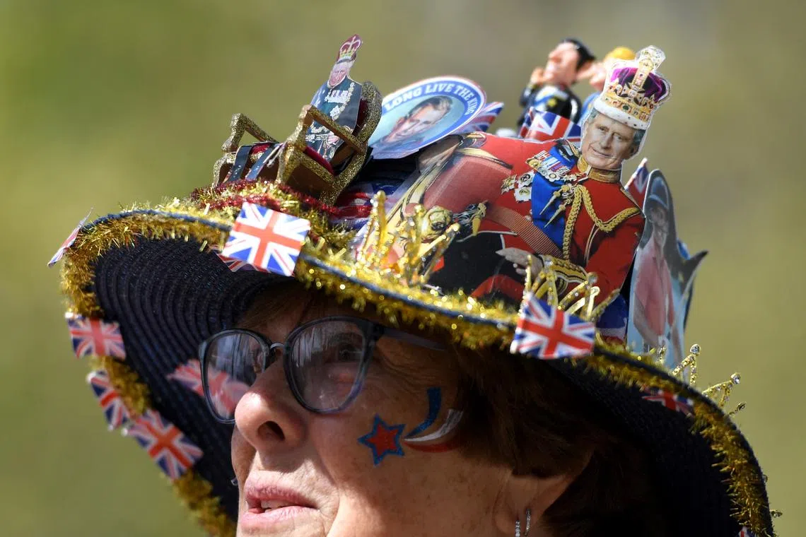 A woman wears a royal-themed hat whilst waiting on the coronation procession route on The Mall in London, Britain, MAY 3, 2023. Britain's King Charles III's coronation will take place at Westminster Abbey in London on May 6, 2023. 