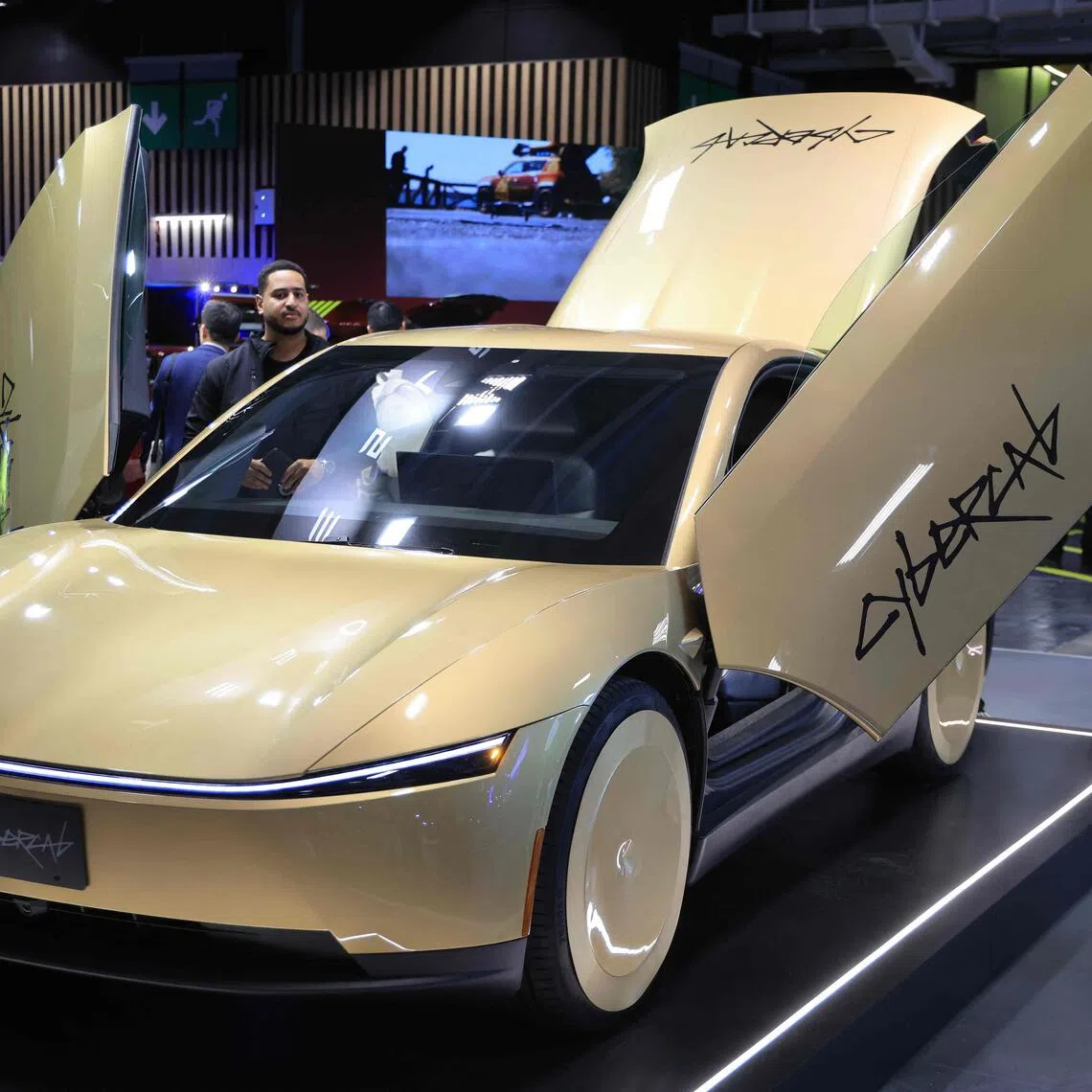 The gold, two-seater car features butterfly doors and drive themselves without any steering wheel, pedals or mirrors.