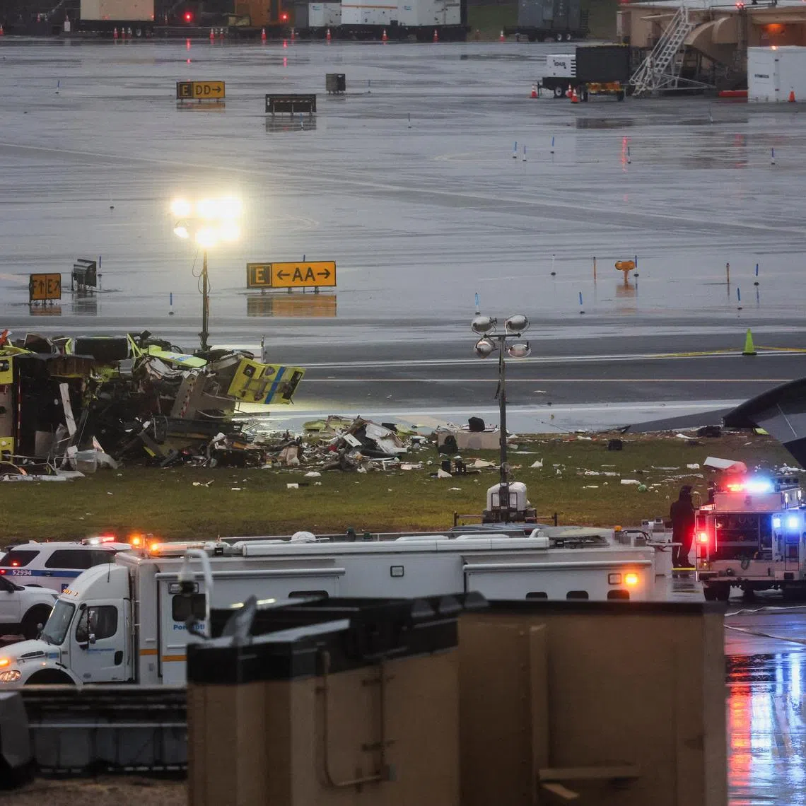 Emergency services work at the scene after an Air Canada Express jet collided with a ground vehicle at LaGuardia Airport.