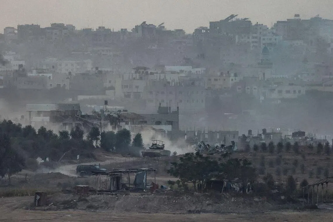 An Israeli tank maneuvers in Gaza as seen from Southern Israel, amid the ongoing conflict between Israel and Palestinian group Hamas, November 10, 2023. REUTERS/Evelyn Hockstein