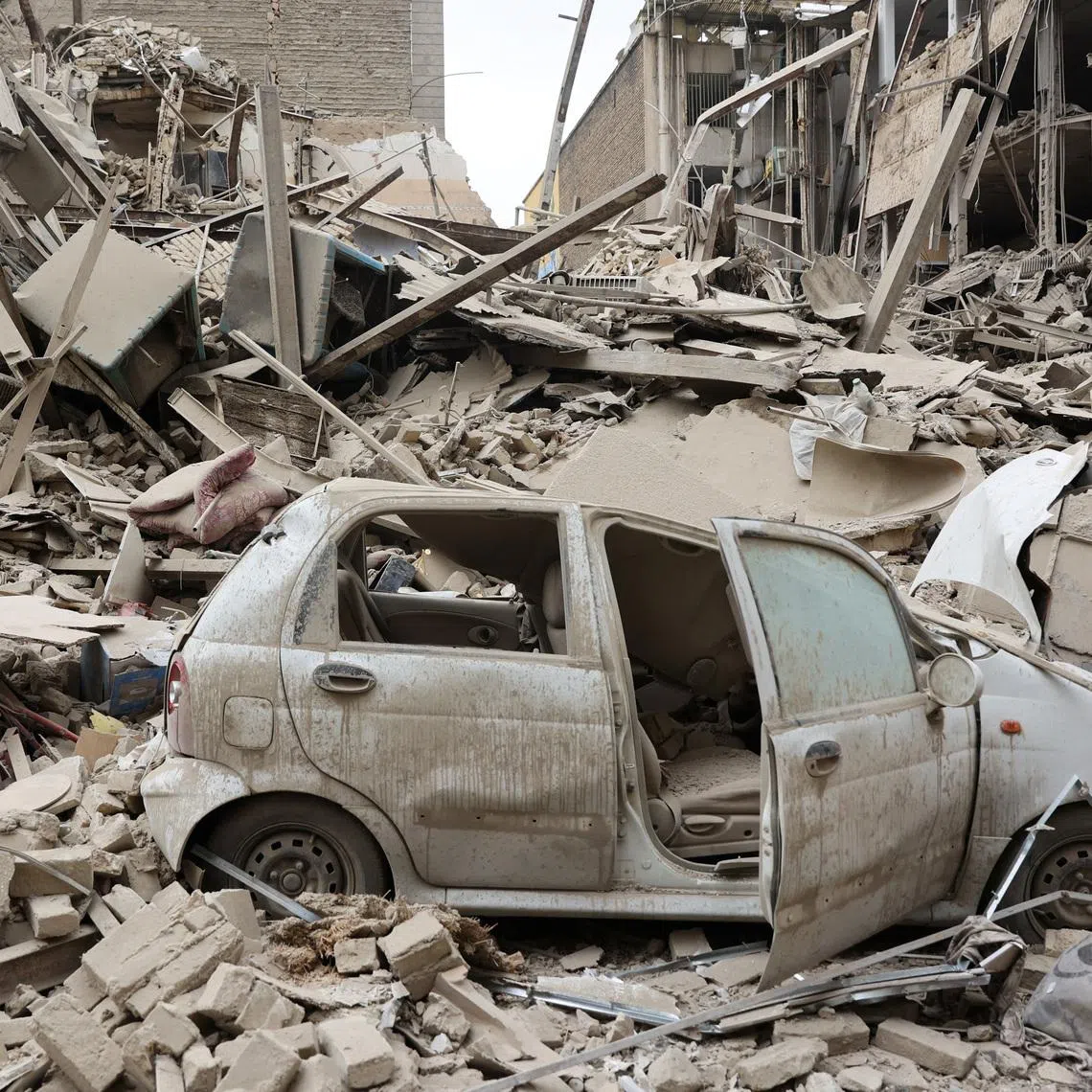 A destroyed vehicle amid rubble at the site of a strike on a residential building, amid the U.S.-Israeli conflict with Iran, in Tehran, Iran, March 16, 2026. Majid Asgaripour/WANA (West Asia News Agency) via REUTERS