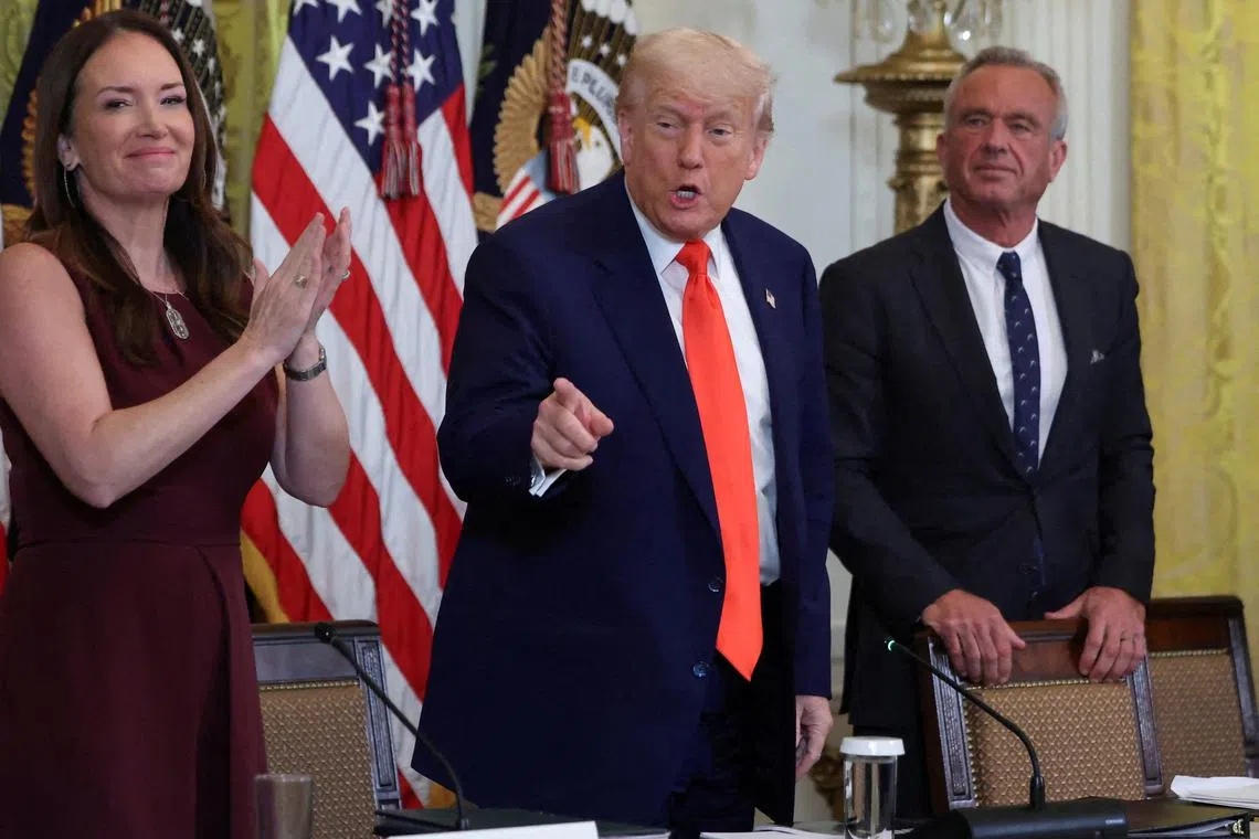 FILE PHOTO: U.S. President Donald Trump, Health and Human Services (HHS) Secretary Robert F. Kennedy Jr.,  Secretary of Agriculture Brooke Rollins attend a Make America Healthy Again (MAHA) Commission event, in the East Room of the White House in Washington, D.C., U.S., May 22, 2025. REUTERS/Evelyn Hockstein/File Photo/File Photo
