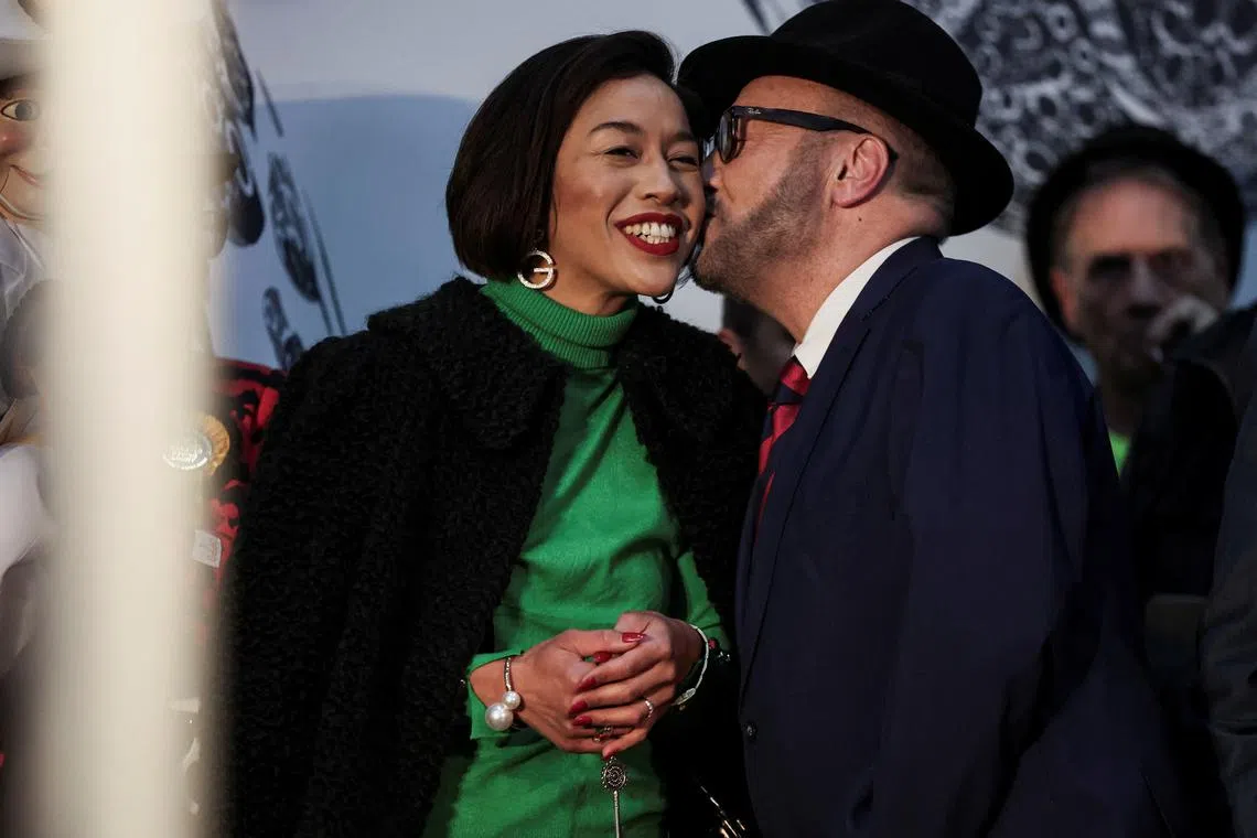 Candidate George Galloway, leader of the Workers Party of Britain, kisses his wife, Putri Gayatri Pertiwi, amidst vote counting during the Rochdale Parliamentary by-election, at a polling station near Manchester, Britain, March 1, 2024. REUTERS/Phil Noble