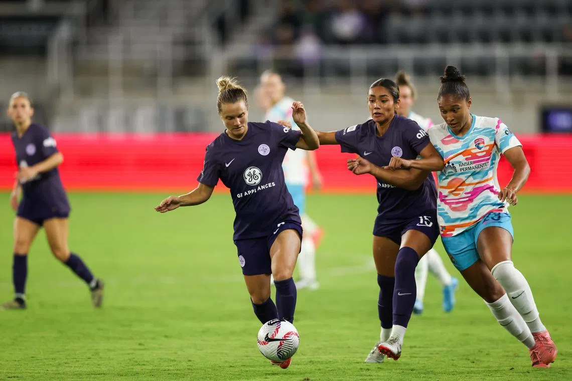 Nov 3, 2024; Louisville, Kentucky, USA;  Racing Louisville FC defender Lauren Milliet (left) and defender Angela Baron (center) and San Diego Wave FC forward Elyse Bennett (right) fight for possession of the ball during the second half at Lynn Family Stadium. Mandatory Credit: EM Dash-Imagn Images/ File Photo