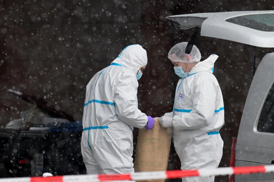 Forensic experts working outside a Jehovah's Witness church in the aftermath of a deadly shooting, in Hamburg, Germany, on March 10, 2023. 