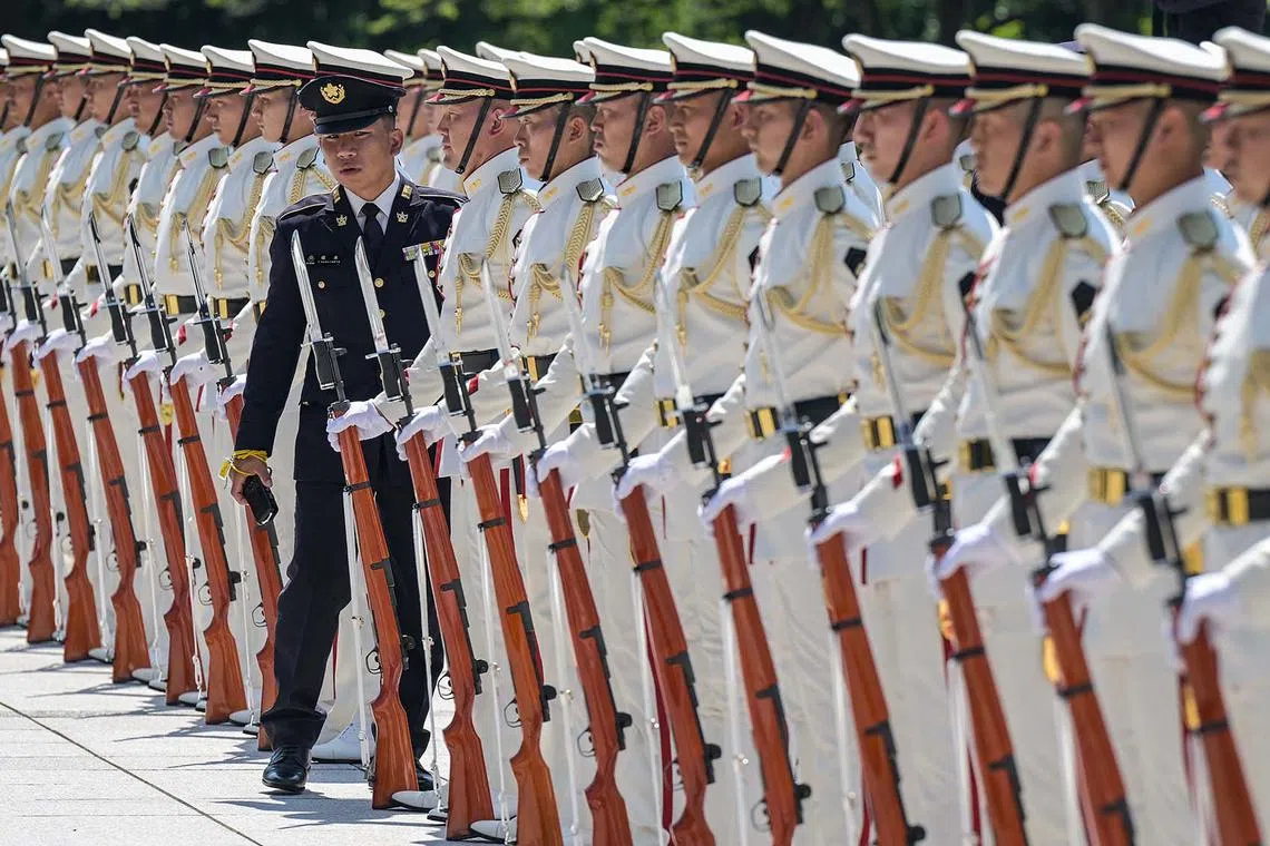 An honour guard standing in formation being inspected before the arrival of Japan's Prime Minister Shigeru Ishiba visit to the Ministry of Defence in central Tokyo on June 30, 2025. 