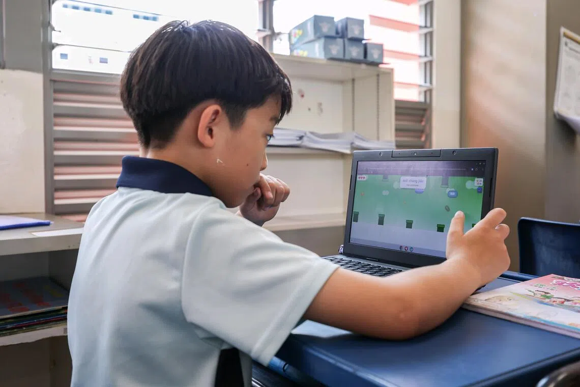 Dazhong Primary School pupil Leong Jun Han playing a version of Flappy Bird created by Chinese language teacher Kenny Ng.