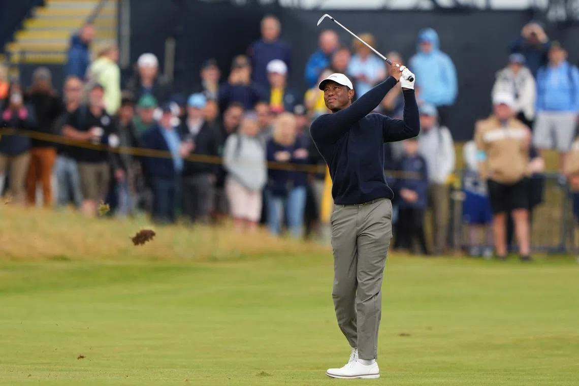 FILE PHOTO: Golf - The 152nd Open Championship - Royal Troon Golf Club, Troon, Scotland, Britain - July 19, 2024 Tiger Woods of the U.S. hits his approach from the 18th fairway during the second round REUTERS/Maja Smiejkowska/File Photo