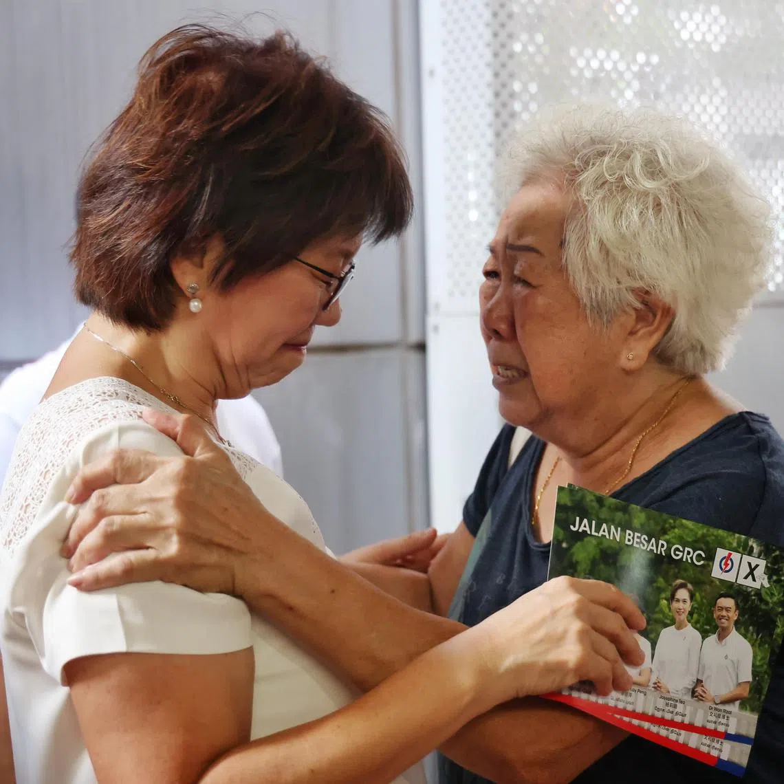 An emotional Madam Yip Lum Fong, 83, rushed to hug Kampong Glam incumbant Denise Phua during the latter's walkabout with the PAP team at North Bridge Road Market and Food Centre on April 30, 2025. Madam Yip told Ms Phua to take care of her own health first before she took care of her residents. ST PHOTO: JASON QUAH