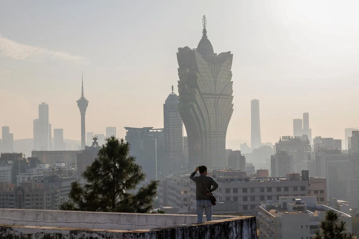 A visitor standing in front of the Grand Lisboa casino in Macau on Dec 17. 