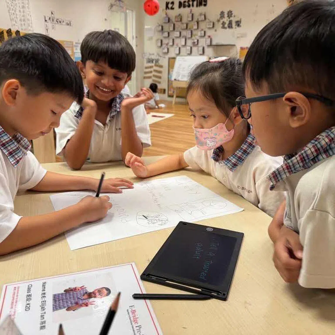 Kindergarten children at E-Bridge Pre-School brainstorming and creating a poster to encourage and advocate online safety.