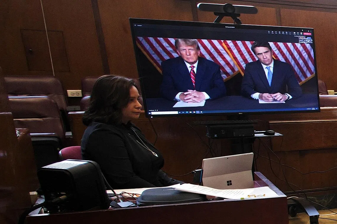 Former US President Donald Trump was seen sitting next to his lawyer Todd Blanche on at least four screens in the courtroom.