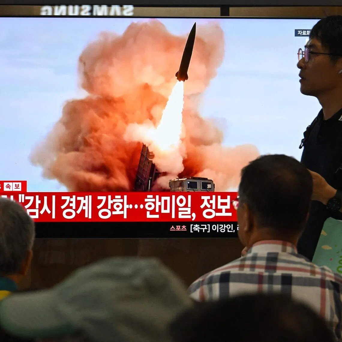 People watching a news broadcast with file footage of a North Korean missile test, at a train station in Seoul on Aug 20.