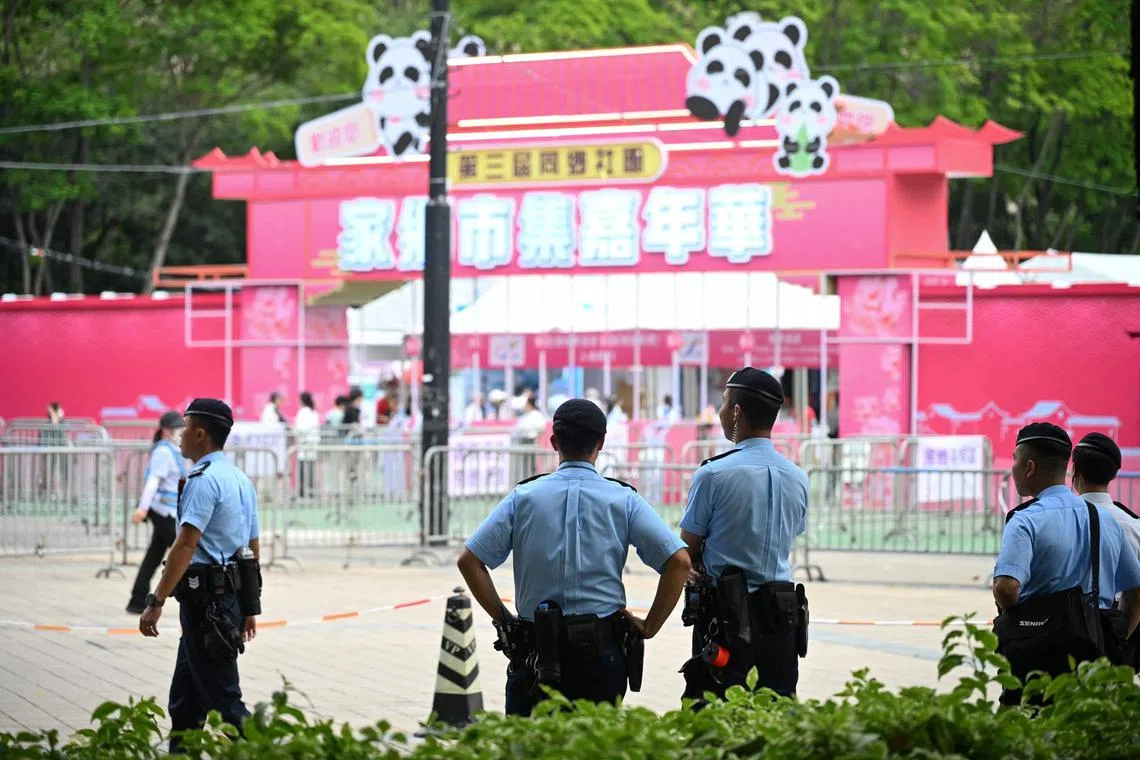 Police patrol outside the entrance of a fair at Victoria Park in Hong Kong's on June 3, 2025, where people traditionally gathered annually on June 4 to mourn the victims of China's Tiananmen Square crackdown.