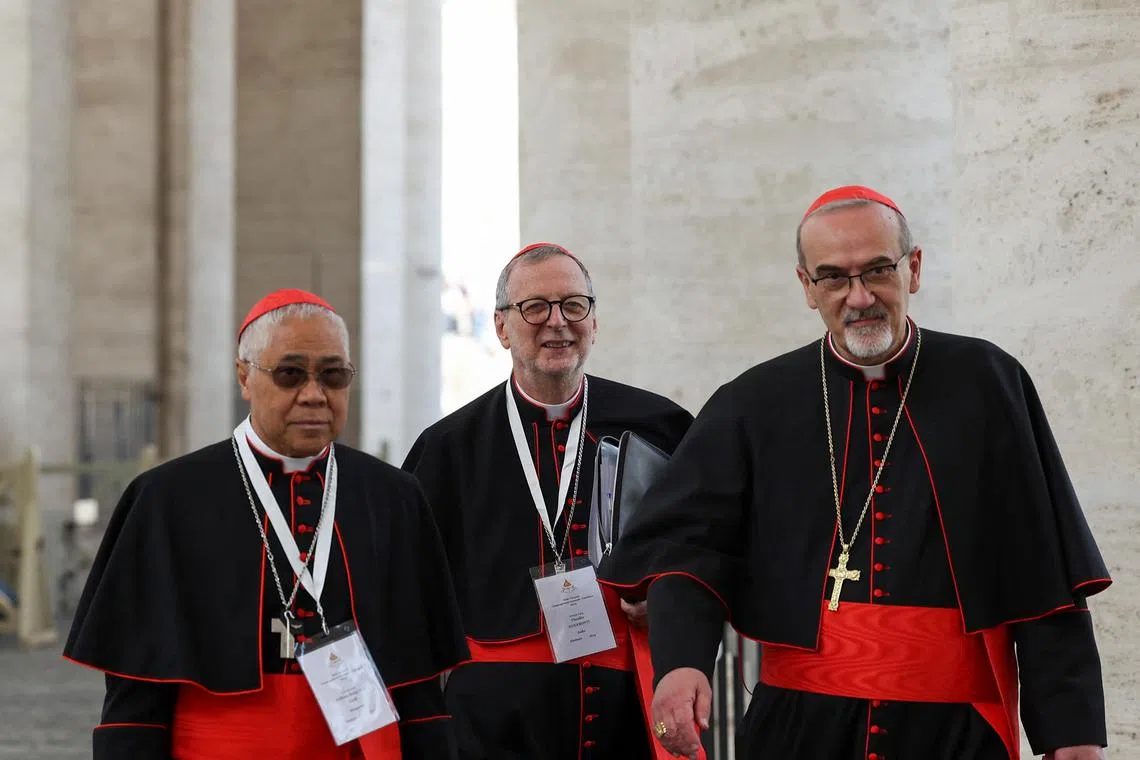 (From left) Cardinals William Goh, Claudio Gugerotti and Pierbattista Pizzaballa, who are among the ones choosing the new pope, leaving a general congregation meeting at the Vatican on May 3. The papal election began on May 7.