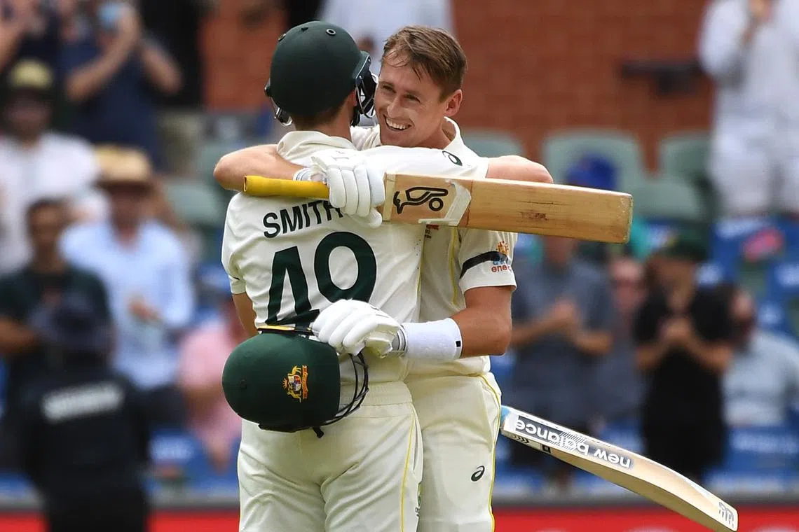 FILE PHOTO: Cricket - Ashes - Second Test - Australia v England - Adelaide Oval, Adelaide, Australia - December 17, 2021 Australia's Marnus Labuschagne reacts after reaching his century with Steven Smith REUTERS/Morgan Sette/File Photo
