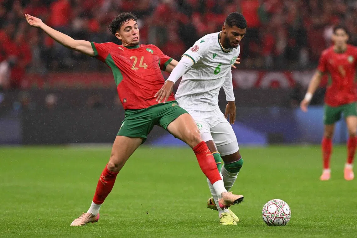 Morocco midfielder Neil El Aynaoui (left) fighting for the ball with Comoros midfielder Iyad Mohamed during Morocco's 2-1 win in their Africa Cup of Nations Group A football match at Prince Moulay Abdellah Stadium in Rabat on Dec 21, 2025.