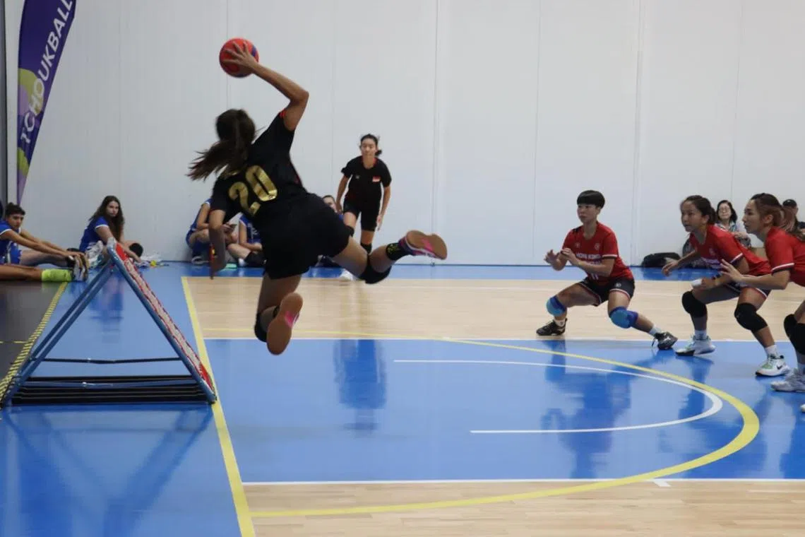 Singapore' vice-captain Ning Rynisari Abdul Wazid shooting the ball as the Singapore women's team suffered a 38-39 to Hong Kong in the quarter-final of the Tchoukball World Championships in Prague on Aug 4.

PHOTO: TCHOUKBALL ASSOCIATION OF SINGAPORE